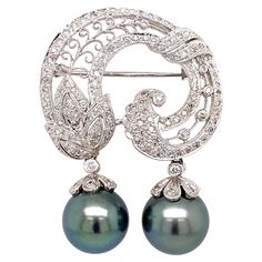 Simply Beautiful! Finely detailed Diamond White Gold Brooch, securely Hand set with Diamonds, approx. 0.86tcw. Suspending 2 - 11.6mm Tahitian Pearls. Hand crafted 18K White Gold Artistically designed Mounting. Measuring approx. 1.65” l x 1.25” w x 0.45” h. Beautiful and Timeless...A sure to be admired touch of Glamor, you’ll turn to time and time again! Fine Pearl Jewelry, Gold Brooch, Gold Brooches, Pearl Brooch, Classy Nails, Tahitian Pearls, Diamond Gold, Art Deco Jewelry, Gold Pearl