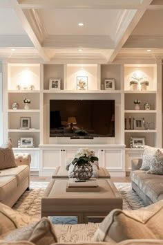 a living room filled with lots of furniture and a flat screen tv mounted on the wall