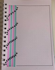 an open notebook with pink, blue and green stripes