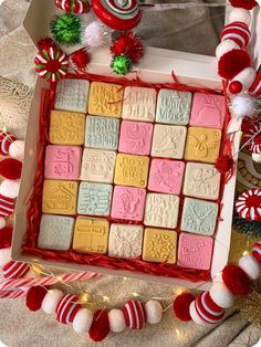 a box filled with lots of candy on top of a table next to christmas decorations