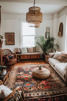 a living room filled with furniture and a large rug on top of a hard wood floor