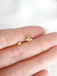 Tiny star stud earrings in two sizes, small and micro - faceted to give a little added sparkle.  Tumble polished to achieve a satin finish.  Sold as a SINGLE (choose options above). PAIRS available here: https://www.etsy.com/listing/686440218/MATERIALStarnish resistant rhodium silver filled/22k gold filled, sterling silver postsDIMENSIONS (LxW)micro: 4mm (just over 1/8")small: 7-8mm (1/4")◊ Matching star jewelry: https://www.etsy.com/shop/kindlingandco/search?search_query=star◊ More stud earring Tiny Star-shaped 14k Gold Jewelry, Dainty Star Cartilage Earrings Gift, Dainty Tiny Star Earrings, Celestial Earrings, Star Stud Earrings, Stud Earrings Silver, Tiny Star, Star Earrings Stud, Cross Ring