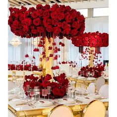 a table set up with red roses and candles for an elegant dinner or wedding reception