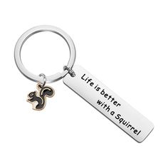 a metal keychain with a black and gold squirrel on it that says, life is better with a squirrel