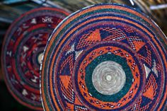 three colorful baskets hanging from the ceiling