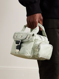 Sacai teams up with Japanese label Porter-Yoshida & Co to create a lineup of bags that combine both brands' unexpected and utilitarian-inspired aesthetics. This scaled-down 'Boston' tote bag has been made in Japan from hardwearing nylon and is fitted with plenty of pockets with a variety of fastenings. It has enough space for your wallet, sunglasses and AirPods. Modern Nylon Shoulder Bag With Multiple Pockets, Green Nylon Bag With Multiple Pockets, Utility Nylon Bag With Zipper Closure, Utility Nylon Bags With Multiple Pockets, Porter Yoshida, Nylon Tote Bags, Nylon Tote, Sport Chic, Boston Bag