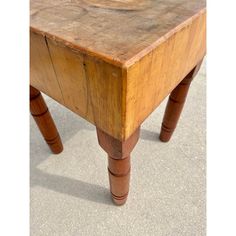 an old wooden table that has been turned into a coffee table with two legs and a bowl on top