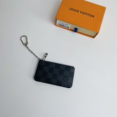 This Damier canvas pouch holds loose change and keys and slips easily into a handbag or coat pocket. Size: 12×7cm Black Pouch With Coin Pocket For Daily Use, Gray Bags With Card Slots For Everyday Use, Rectangular Travel Pouch With Key Clip, Everyday Gray Bag With Card Slots, Modern Black Wallet With Key Clip, Black Bags With Coin Pocket For Gifts, Modern Black Pouch With Card Slots, Black Bag With Coin Pocket As Gift, Everyday Black Bag With Key Clip