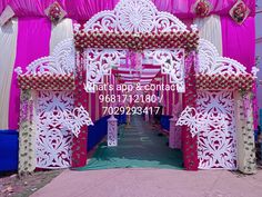 the entrance to a wedding ceremony with pink and white decor on it's sides