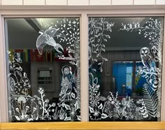 the window is decorated with white frosting and has an image of people on it