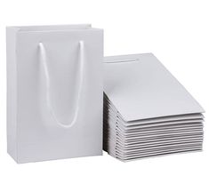 white paper bags stacked on top of each other