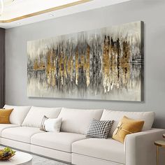 a living room filled with white couches and a painting on the wall above it