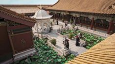 an aerial view of a courtyard with lots of plants and people walking around the area