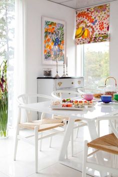 a dining room table with plates and bowls on it