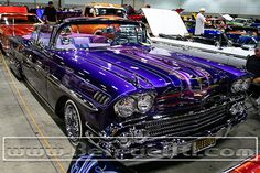 classic cars are on display at an auto show