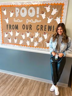 a woman standing in front of a sign that says poop from our crew