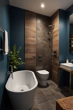 a bathroom with a toilet, sink and bathtub in the middle of the room