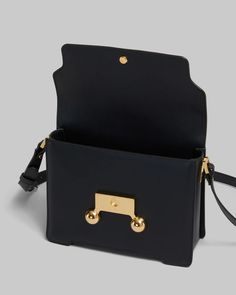 FINAL SALE The Black Leather Trunkaroo Medium Shoulder Bag by Marni is a rectangular shoulder bag featuring a front flap with magnetic closure and engraved Marni lettering, contoured base, and oversized stud detail. Detachable and adjustable buckled shoulder strap: can also be worn as a clutch. Made in Italy Body: 100% Calf Leather - Lining: 100% Ovine Leather - Metallic Parts: 100% Brass - Metallic Parts: 100% Steel SBMP0195U0P694800N99 Boot Pumps, Medium Bags, Thom Browne, Boot Sandals, Shoe Sale, Magnetic Closure, Victoria Beckham, Me Too Shoes, Calf Leather