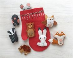 an assortment of stuffed animals sitting on top of a red stocking