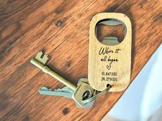 a bottle opener with a wooden key attached to it on top of a wood table