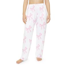 Coquette, pink bow pajama pants.   Very popular for young ladies Here to add style on luxurious comfort, these custom photo pajama pants are made with 100% brushed polyester that feels extra cozy to slip into. The soft and stretchy fabric makes it perfect for sleeping or lounging around home while your prints come to life in vivid detail and color for extra style points.  .: Material: 100% brushed polyester .: Light fabric (5.6 oz/yd² (190 g/m .: Elastic waistband .: Printed-in size and care lab Cute Pink Sleepwear With Long Pants, Cute Pink Sleepwear Long Pants, Feminine Long Pants Sleepwear For Pajama Party, Feminine Sleepwear With Long Pants For Pajama Party, Cute Pink Bedtime Pants, Feminine Pink Bottoms For Pajama Party, White Feminine Bottoms For Pajama Party, Cute Pink Sleepwear, Coquette Pajamas