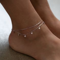 Dress up plain pumps or flats with this chic anklet featuring dangling polished discs on a layered chain. .925 Sterling Silver 4mm Discs Hypoallergenic, lead, and nickel free Length: 9in (22cm) + Extension: 1in (2.5cm) Lobster clasp closure Handcrafted in NYC #ANK014 Aesthetic Silver Anklets, Silver Anklet Aesthetic, Minimal Anklet, Cute Anklets, Body Decor, Local Eclectic, Crystal Anklet, Silver Anklet, Lana Jewelry