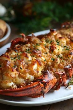 cooked lobsters on a white plate with parsley sprinkled on the side