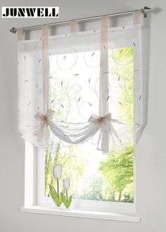 a white window with sheer curtains and tulle