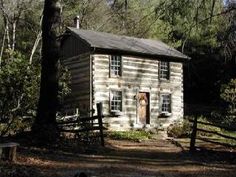 an old log cabin sits in the woods