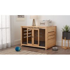 a large wooden cabinet with two doors and some drawers on top of it, next to a potted plant