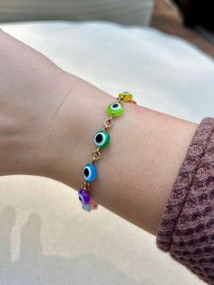 Multicolor rainbow evil eye gold chain link bracelet! Minimalist boho jewelry style. Select size from the dropdown menu. Hand-crafted with love and care. ~ More Evil Eye Bracelets ~ White Freshwater Pearl: https://shopcrystalelements.etsy.com/listing/1659617834 Multicolor Heishi Bead Stretch: https://shopcrystalelements.etsy.com/listing/1678043091 Red Seed Bead Stretch: https://shopcrystalelements.etsy.com/listing/1641157566 Silver Stretch: https://shopcrystalelements.etsy.com/listing/1719950613 Trendy Adjustable Multicolor Chain Bracelet, Trendy Multicolor Adjustable Chain Bracelet, Multicolor Metal Everyday Jewelry, Multicolor Everyday Metal Jewelry, Everyday Multicolor Metal Jewelry, Dainty Multicolor Bracelets With Adjustable Chain, Trendy Hypoallergenic Rainbow Jewelry, Trendy Rainbow Hypoallergenic Jewelry, Multicolor Evil Eye Jewelry