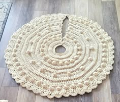 a crocheted round rug on the floor