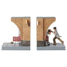 the figurines are made out of bricks and include a man pushing a luggage cart