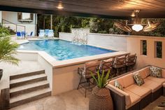 a living room with a pool and patio furniture