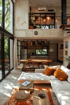 a living room filled with lots of furniture next to a staircase leading up to a second story