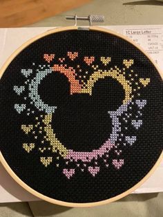 a cross - stitch mickey mouse design on a piece of paper