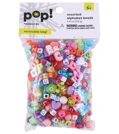 a bag of assorted alphabet beads with the word pop on it's side