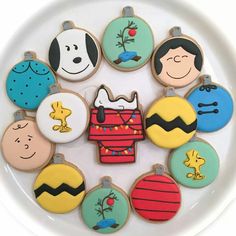 decorated cookies in the shape of cartoon characters on a plate