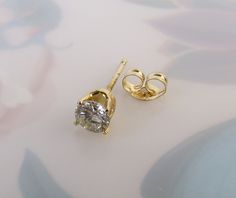 "This listing is for 1 (SINGLE) Vintage diamond 14k yellow gold stud post earring. It is perfect for the person who wears only one earring on one side or has multiple piercings on their ear or ears. A certified gemologist verbally verified the diamond as genuine and graded it with an SI2 (si2) clarity and I-J color. The 3.70mm round brilliant-cut gem has an approximate weight of .20 carat. It has a nice sparkle to it and four sturdy prongs hold it tightly in the 14k yellow gold crown style setti Anniversary Solitaire Yellow Gold Diamond Earrings, 14k Yellow Gold Solitaire Earrings, Gold Solitaire Diamond Earrings For Anniversary, Yellow Gold Solitaire Earrings With Cubic Zirconia, Gold Solitaire Round Earrings, Yellow Gold Solitaire Earrings, Round Cut, Yellow Gold Solitaire Earrings Round Cut, Gold Solitaire Earrings, Diamond White Solitaire Diamond Earrings In 14k Gold