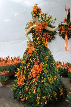 a woman in a dress made out of flowers