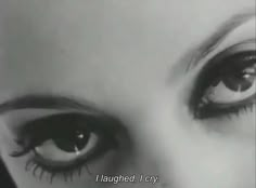 an old black and white photo of a woman's eyes