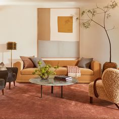 a living room filled with furniture and a painting on the wall above it's coffee table