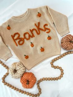 It's pumpkin season, y'all!  A customized name sweater is the perfect way to announce your new baby and welcome them to the world. They also make great gifts that add a personal touch. Sweaters can also be saved and remembered as a keepsake when your little one outgrows it.  Each sweater is hand-embroidered and uniquely made - no two sweaters are the same! Customize colors to create a one-of-a-kind sweater for your little one.  SWEATER IN PICTURE:  "Beige" 12-18m sweater "Pumpkin" yarn - - - - - Pumpkin Knit Sweater, Pumpkin Embroidery Sweater, Customizable Cotton Sweater For Fall, Customizable Cotton Fall Sweater, Embroidered Sweaters, Hanging By A Thread, Name Sweater, Thanksgiving Sweater, Sweater Pumpkins