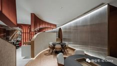 the interior of an office building with wood and glass walls, white chairs and tables