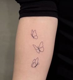 three butterflies tattoo on the left arm