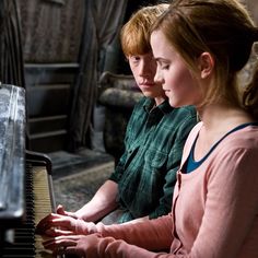 two young children are playing the piano together