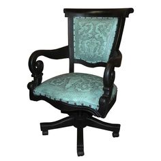 an old fashioned desk chair with green upholstered fabric on the armrests