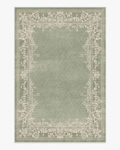 a green rug with an ornate border