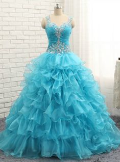 Garden-inspired and so very graceful, this Luxury Blue Crystal Ruffles Sweetheart Organza Quinceanera Dress by Kemedress is simply stunning. Floor length ball gown silhouette with straps sweetheart neckline, beading and sequins & beading embellishments with blue organza is well blend of Luxury Blue Crystal Ruffles Quinceanera Dress. Its Multiple layers of organza come together on the bodice creating a softer feeling, while the sequins & beading detailing adds a hint of shimmer and textural feel. This dress can come with a zipper closure with a lace-up option make its shape much delight. Prom Dresses With Straps, Prom Dresses Long Elegant, Long Elegant Prom Dresses, Dresses With Straps, Dresses Long Elegant, Custom Made Prom Dress, Blue Organza, Quinceanera Dresses Blue, Gold Prom Dresses