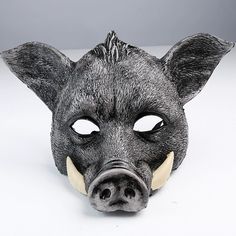 a black pig mask with horns on it's head